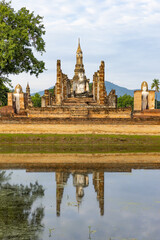 Fototapeta premium Panorama of ancient Buddha statue and ruin of temple of Wat mahathat temple in Sukhothai Historical Park, which also one of UNESCO Heritage Site