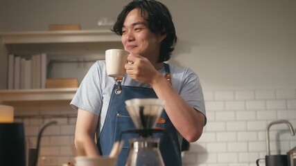 Young Asian man making drip coffee,Grind coffee savor the aroma and flavor at home kitchen in morning vibe,cheerful barista making coffee pouring hot water into dripper,morning lifestyle vibes concept