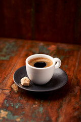 Cup of coffee on rustic wooden background. Soft focus. Copy space	