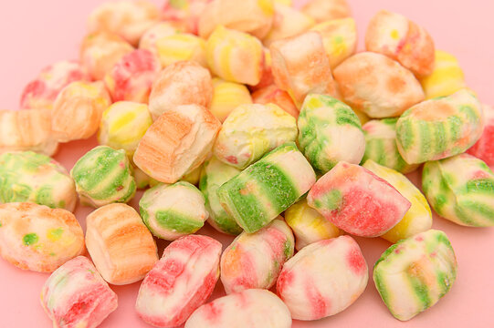Sweet multi-colored sugar candies on a white background. Close-up.