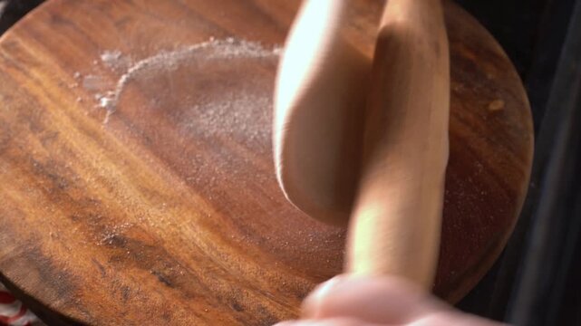 Close-up of a woman hand making Indian roti or chapati at home. Traditional flatbread preparation at  kitchen