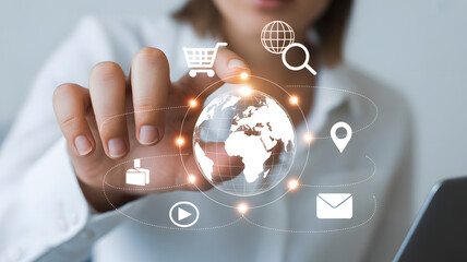 Digital Interaction: A person interacts with a digital globe, adorned with icons. Illustrating the cutting edge of connectivity.