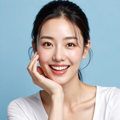 Fototapeta premium Asian woman smiling with hand on face, blue background, skincare marketing image, product advertisement, beauty campaign, diverse female model, white shirt, promotional material