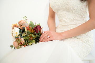 Bride Showcasing Elegant Ring While Waiting for Ceremony Inside a Beautifully Decorated Venue