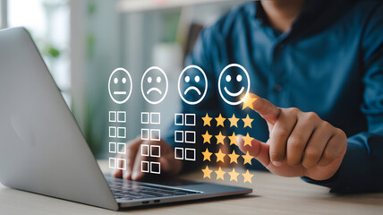 Customer Experience Satisfaction: A person's finger touches a smiling face icon on a laptop screen, symbolizing excellent customer service and positive feedback, showcasing a star rating system.