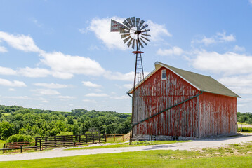 Rustic Red Barn with Classic Windmill on a Sunny Summer Day