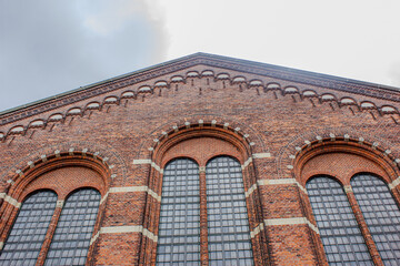 Red Brick Building with Large Arched Windows in Historic Architecture Style