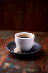 Cup of coffee on rustic wooden background. Soft focus. Copy space	