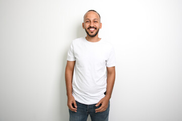 Fototapeta premium young islamic arab man against white studio wall