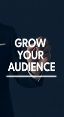 Hand writing "Grow Your Audience" on dark background, showcasing business growth and audience engagement concepts