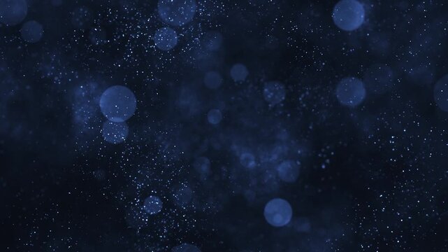 Atmospheric blue abstract background with glittering shiny particles and shimmering bokeh light spheres. Magical stardust effect.