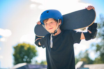 nice Boy with skateboards outside on skate playground