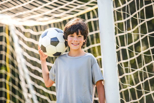 kid play football or soccer on a outdoor field