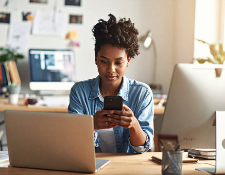 Young African American black woman working on laptop and mobile phone