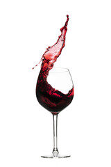 Vibrant red wine splashing from a bottle, pouring into a glass on a white background