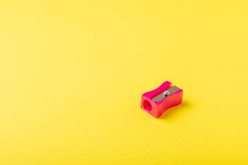 Pencil sharpener on bright colored background. Pencil and pencil shavings. Stationery. School...