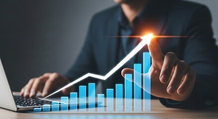 Businessman touching a rising graph on a laptop screen