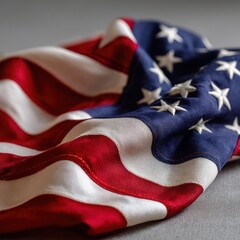 American flag close up showing stars and stripes on a gray surface