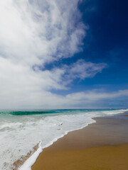 beach and sea with blue sky and white clouds