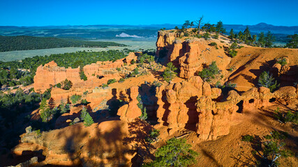 Aerial Red Canyon Hoodoos and Rock Formations with Green Forest Utah