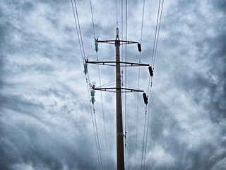 Power lines against a moody sky during the late afternoon in an urban setting