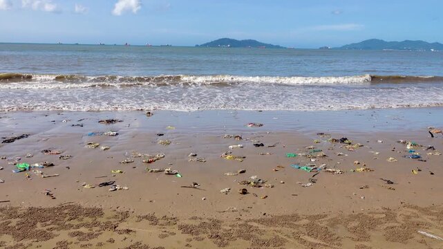 There are a lot of plastic bags in the surf strip of the sandy beach. The Sulu Sea