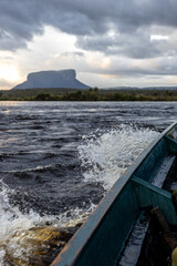 Tabletop mountain tepui in Canaima National Park, Venezuela at sunrise, with river and tree