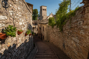 Naklejka premium Beautiful Tuscan historical street and place in the city of Assisi, Tuscany, Italy, Europe. Medieval atmosphere