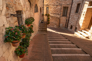 Naklejka premium Beautiful Tuscan historical street and place in the city of Assisi, Tuscany, Italy, Europe. Medieval atmosphere