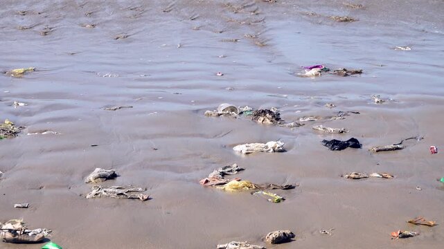 There are a lot of plastic bags in the surf strip of the sandy beach. The Sulu Sea