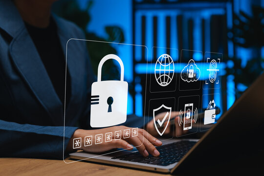 Businesswoman using laptop with virtual lock and cybersecurity icons. Concept of data protection, online privacy, password security, cloud safety, and digital identity verification in secure systems.