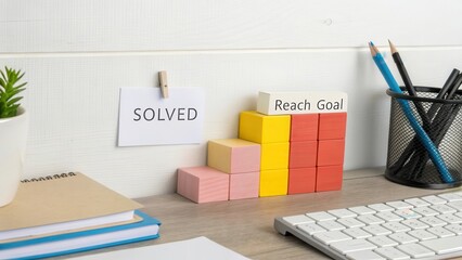 Workspace with Solved Note and Colorful Building Blocks for Goals
