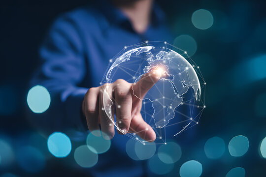 World Connectivity: A hand reaches out to touch a glowing globe, symbolizing global connection and modern technological innovation, set against a backdrop of vibrant bokeh.