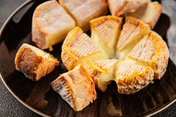 Cheese plate camembert, brie, munster french cheese tasty snack fresh delicious gourmet food background on the table rustic food top view copy space