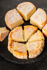 Cheese plate camembert, brie, munster french cheese tasty snack fresh delicious gourmet food background on the table rustic food top view copy space