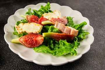 Salad figs, soft cheese, green leaf lettuce tasty snack fresh delicious gourmet food background on the table rustic food top view copy space keto and paleo diet vegetarian food