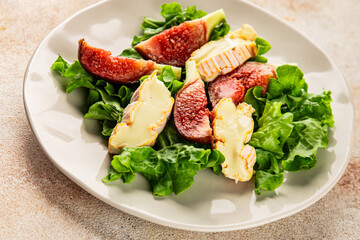 Salad figs, soft cheese, green leaf lettuce tasty snack fresh delicious gourmet food background on the table rustic food top view copy space keto and paleo diet vegetarian food