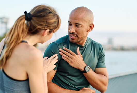 Young  couple jogging together, helping and supporting each other with a injury problem  in the park