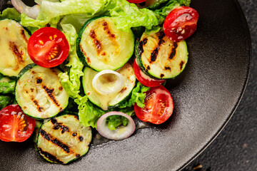 Salad grilled zucchini, tomato, lettuce tasty snack fresh delicious gourmet food background on the table rustic food top view copy space keto and paleo diet vegan and vegetarian food