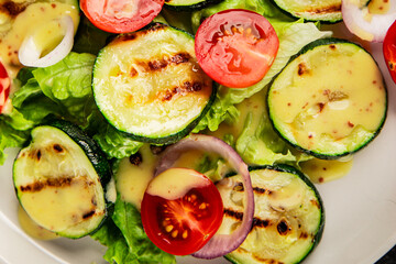 Salad grilled zucchini, tomato, lettuce tasty snack fresh delicious gourmet food background on the table rustic food top view copy space keto and paleo diet vegan and vegetarian food