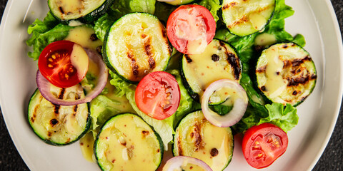 Salad grilled zucchini, tomato, lettuce tasty snack fresh delicious gourmet food background on the table rustic food top view copy space keto and paleo diet vegan and vegetarian food