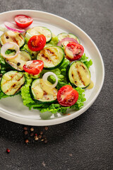 Salad grilled zucchini, tomato, lettuce tasty snack fresh delicious gourmet food background on the table rustic food top view copy space keto and paleo diet vegan and vegetarian food