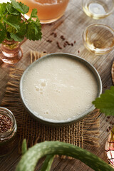 Homemade shampoo made with flax seed gel, argan oil, apple cider vinegar, nettle and coco glucoside. Alternative no poo haircare.