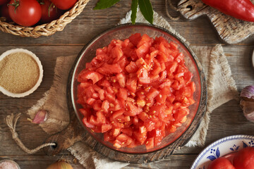 Peeled and chopped tomatoes and spices - preparation of homemade tomato relish (ajvar-style vegetable spread, chutney or bruschetta topping)