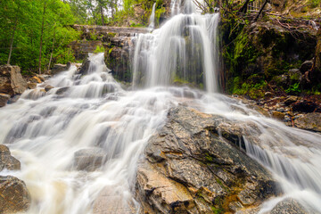 Naramata Creek Park Waterfall cascades through lush greenery in British Columbia, Canada.
