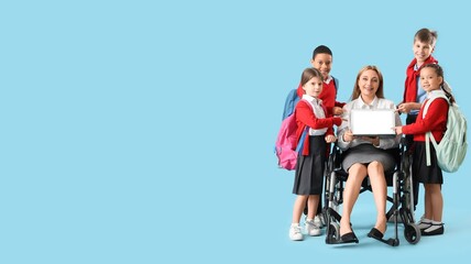 Obraz premium Mature female teacher in wheelchair and little students on blue background with space for text