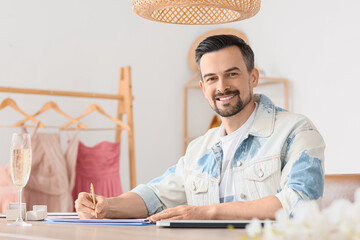 Male wedding planner working in office