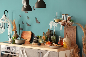 Interior of kitchen decorated for Halloween with counter and lamps