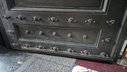 Rome, Italy - 10 January 2025. The lower section of the Pantheon’s bronze entrance door shows...