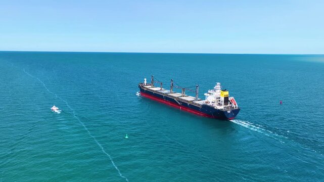 Bulk carrier BARBRO G sailed on St. Clair River to Lake Huron aerial view. This river divided Port Huron, Michigan, USA and Point Edward, Ontario, Canada. 